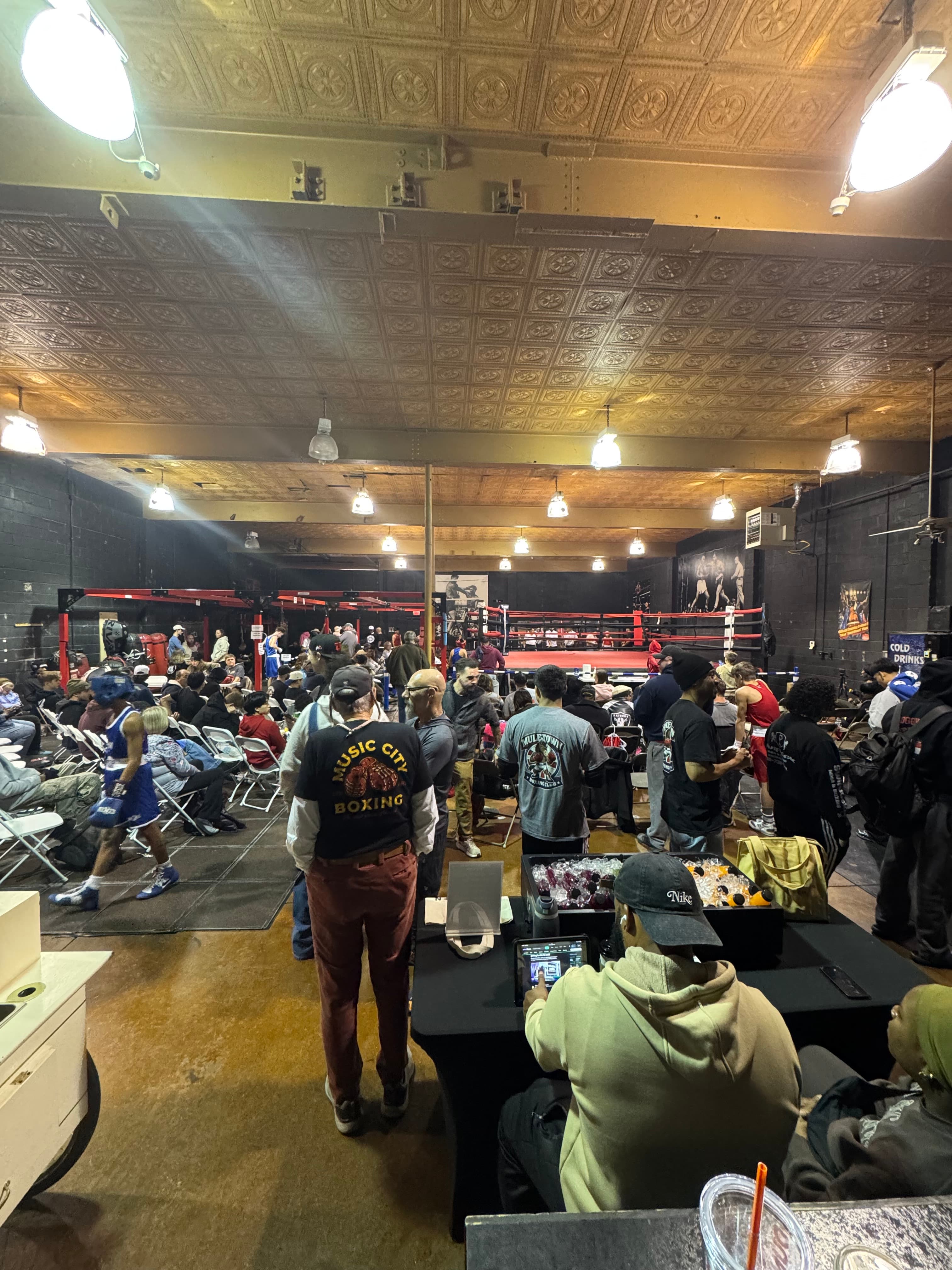 Crowd at a fight night event inside Music City Boxing